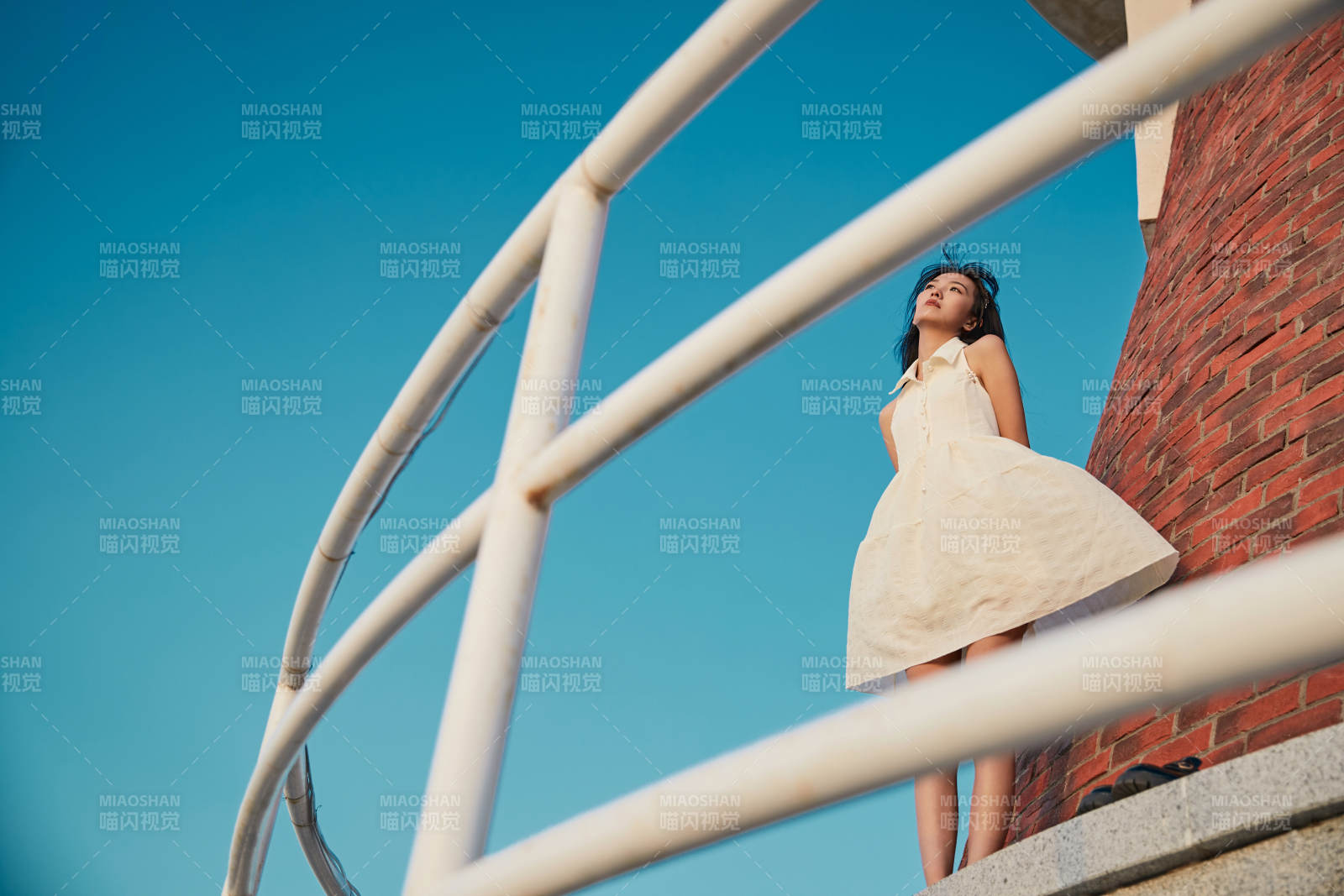 盛夏夕阳湖边码头灯塔上吃西瓜的少女图片