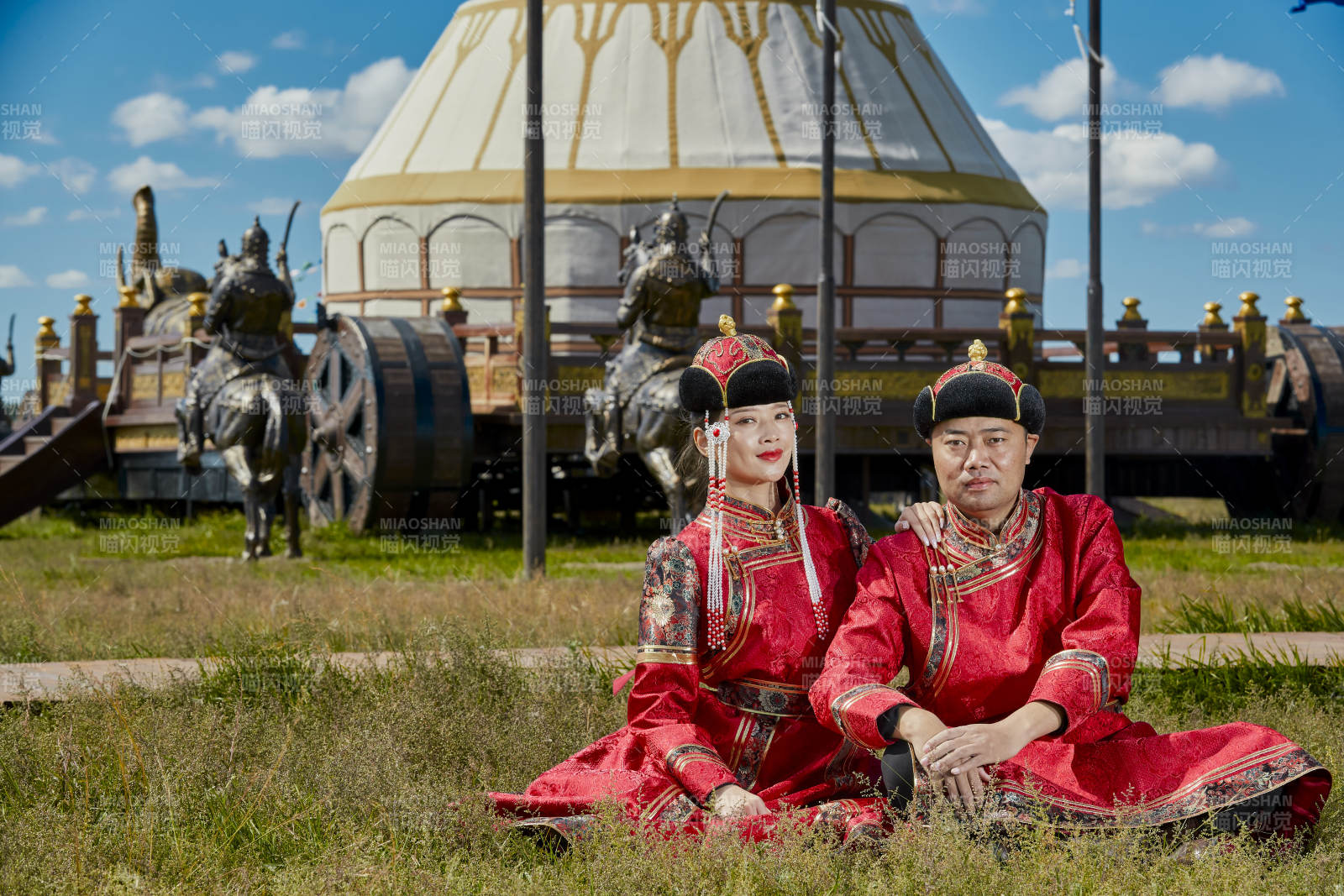 草原上蒙古包前穿蒙古族传统服饰的年轻夫妻图片