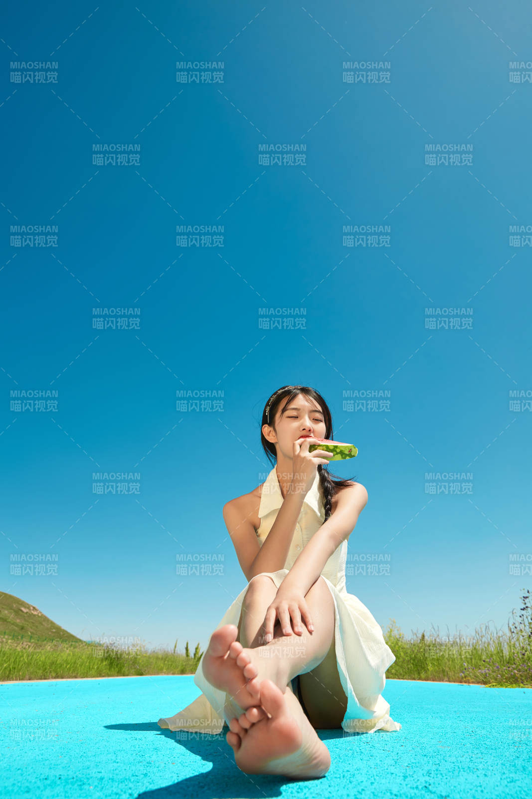 夏日户外湖边彩色公路上玩耍吃西瓜的少女图片