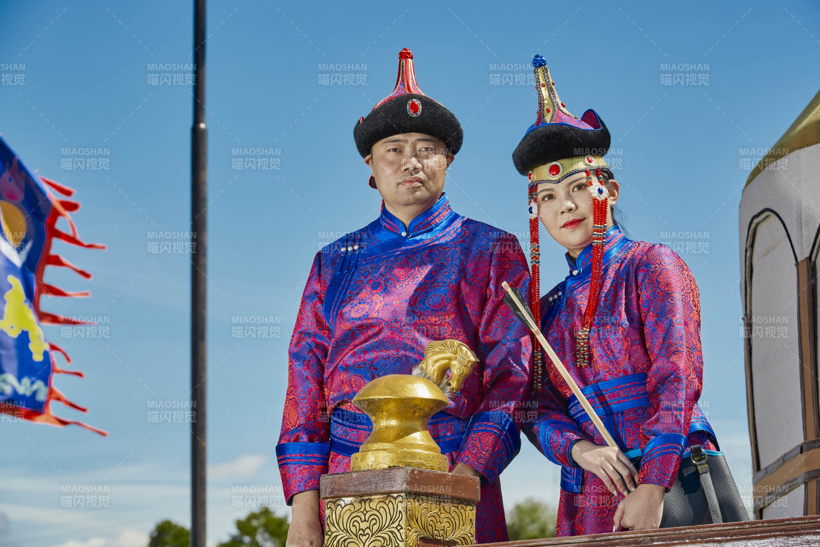 草原上蒙古包前穿蒙古族传统服饰的年轻夫妻图片