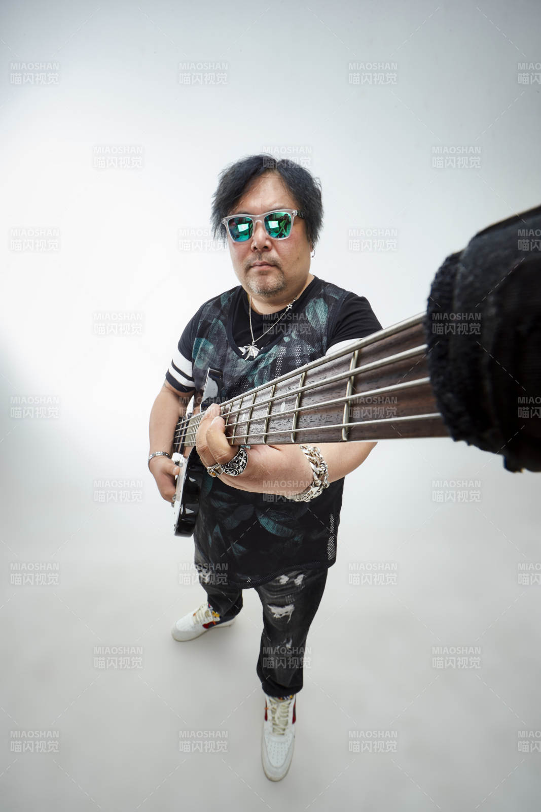 手持贝斯.低音吉他展示演奏的男性乐手人像图片