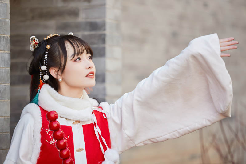 身穿喜庆汉服在古城游玩的少女图片