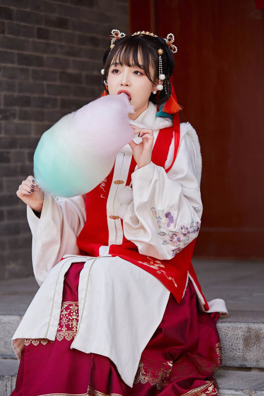 身穿喜庆汉服吃棉花糖的少女图片
