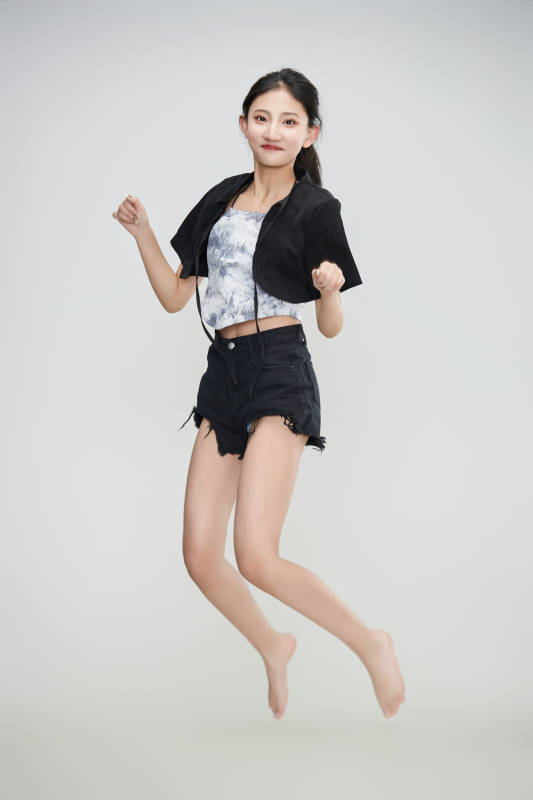 白色背景下腾空跳跃的可爱亚洲少女图片