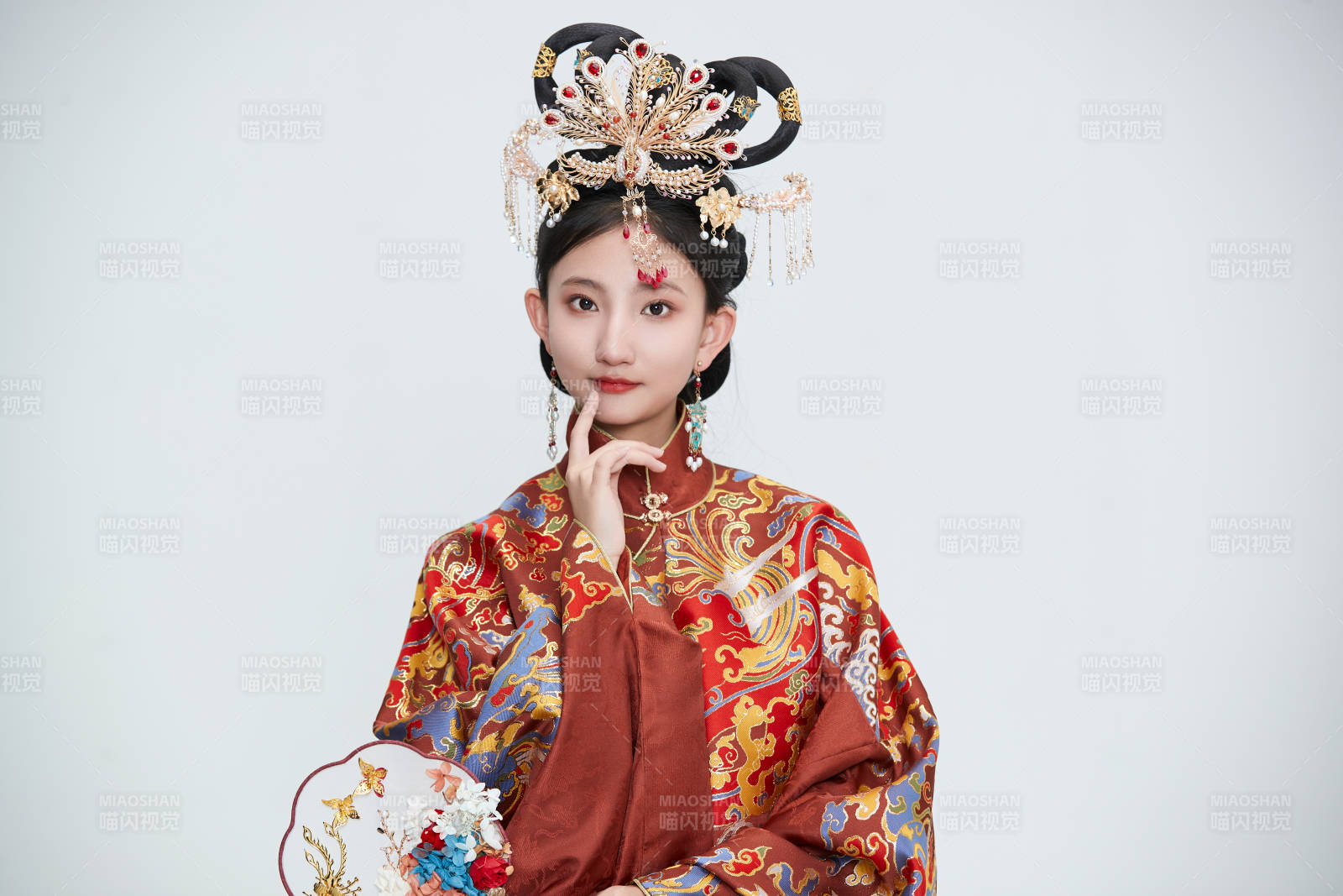 白色背景下穿着明代凤冠霞帔汉服的可爱少女图片