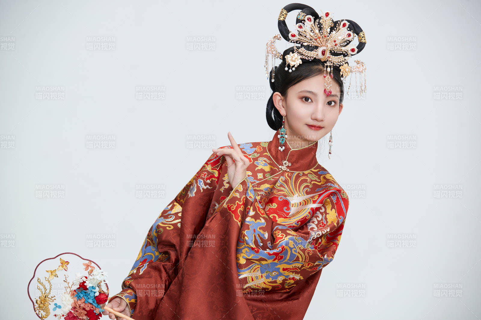 白色背景下穿着明代凤冠霞帔汉服的可爱少女图片