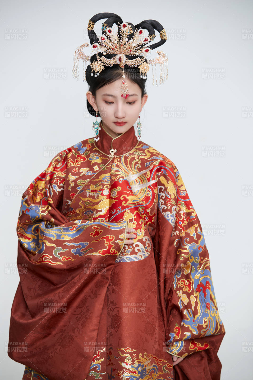 白色背景下穿着明代凤冠霞帔汉服的可爱少女图片