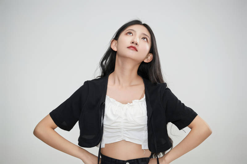 白色背景下做各种面部表情的可爱亚洲少女图片