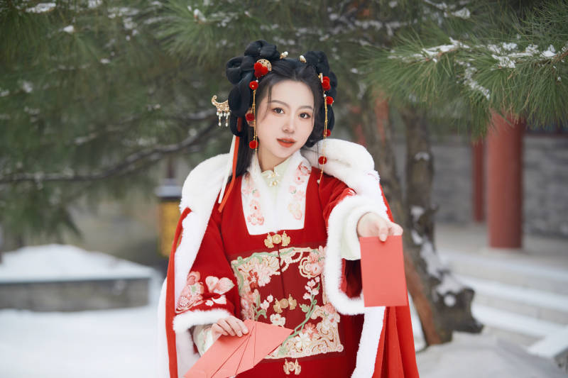 雪天户外身穿中式红色汉服的亚洲少女图片