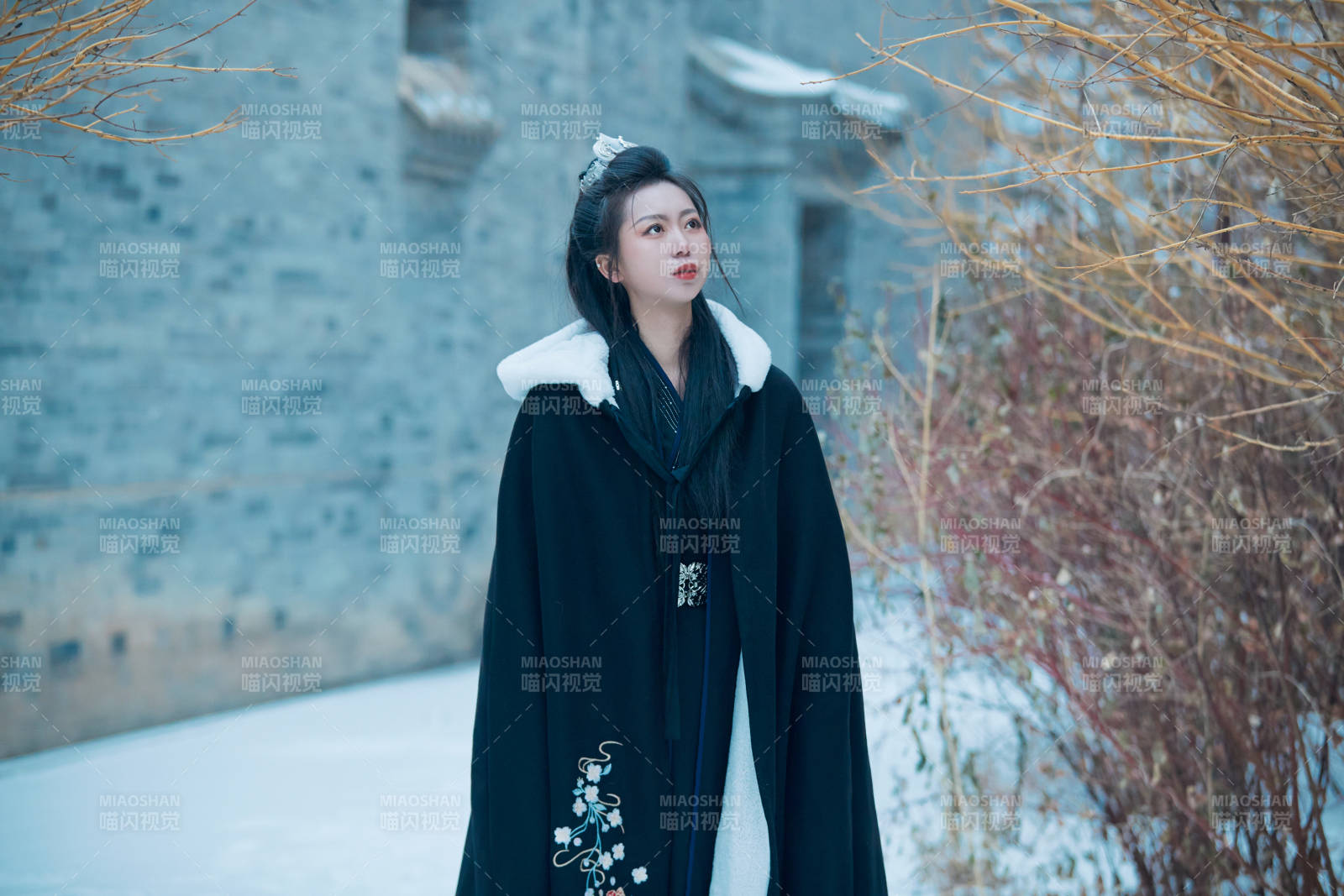 雪天古城身穿汉服扮演武侠的中国少女图片