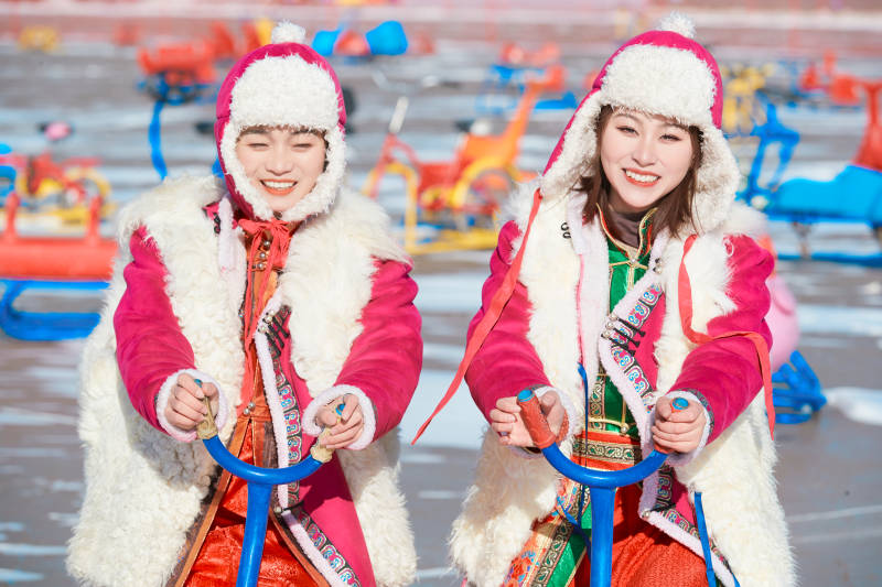 冬天在冻结湖面玩嬉戏滑冰的闺蜜少女图片