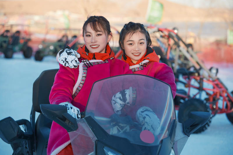 在冰天雪地玩耍雪上娱乐载具车辆的闺蜜少女图片