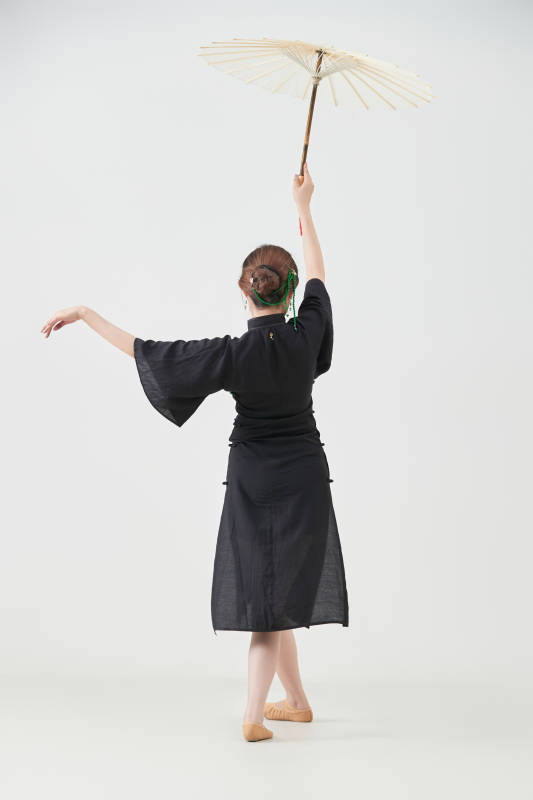 穿中式旗袍手拿油纸伞翩翩舞蹈的亚洲少女舞者图片