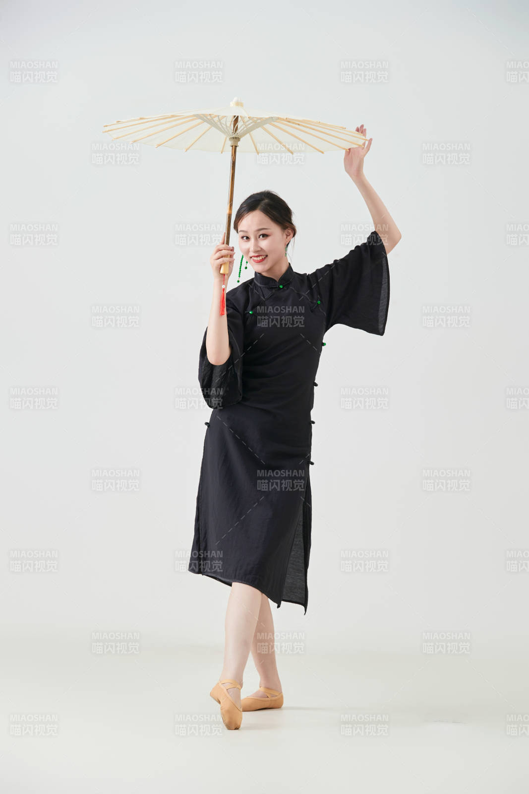 穿中式旗袍手拿油纸伞翩翩舞蹈的亚洲少女舞者图片