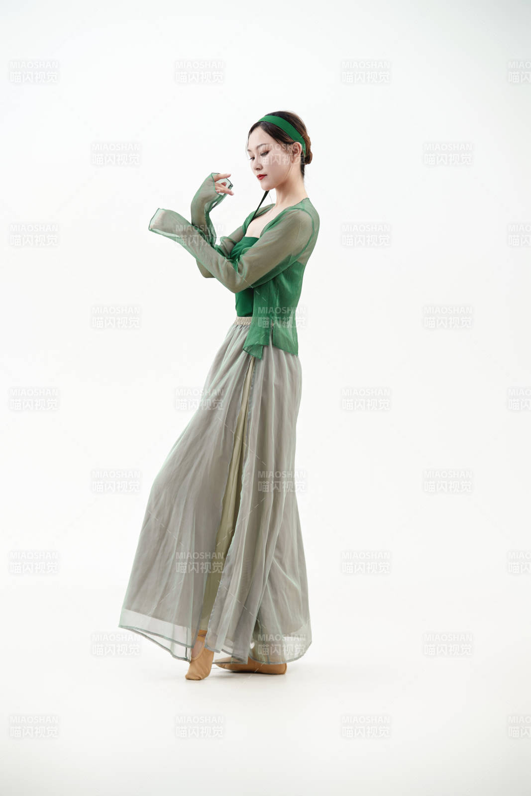 身穿青色古典舞蹈服装手拿蒲扇跳舞的少女图片