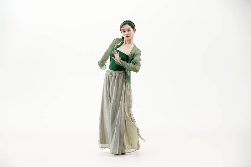 身穿青色古典舞蹈服装手拿蒲扇跳舞的少女图片