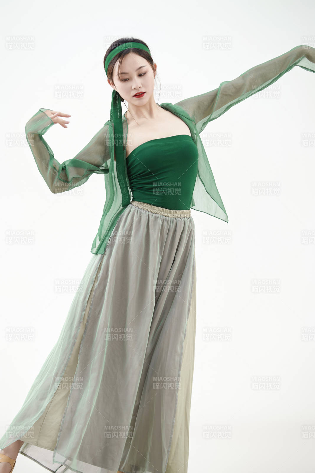 身穿青色古典舞蹈服装手拿蒲扇跳舞的少女图片