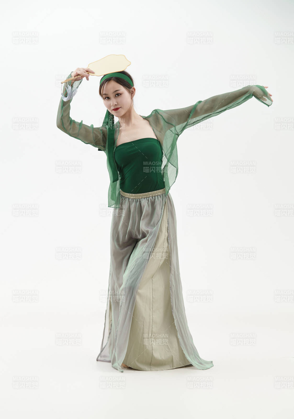 身穿青色古典舞蹈服装手拿蒲扇跳舞的少女图片