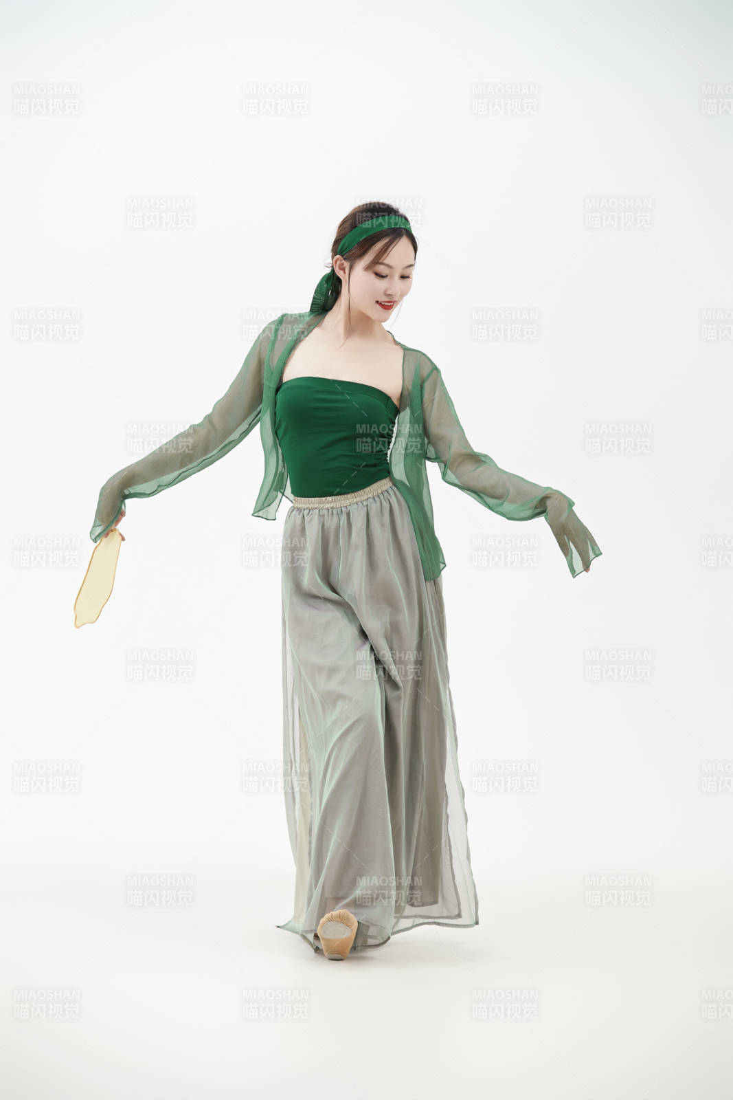 身穿青色古典舞蹈服装手拿蒲扇跳舞的少女图片