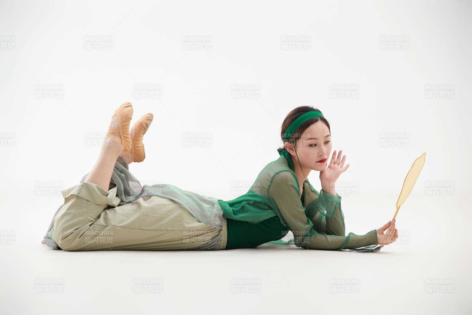 身穿青色古典舞蹈服装手拿蒲扇跳舞的少女图片