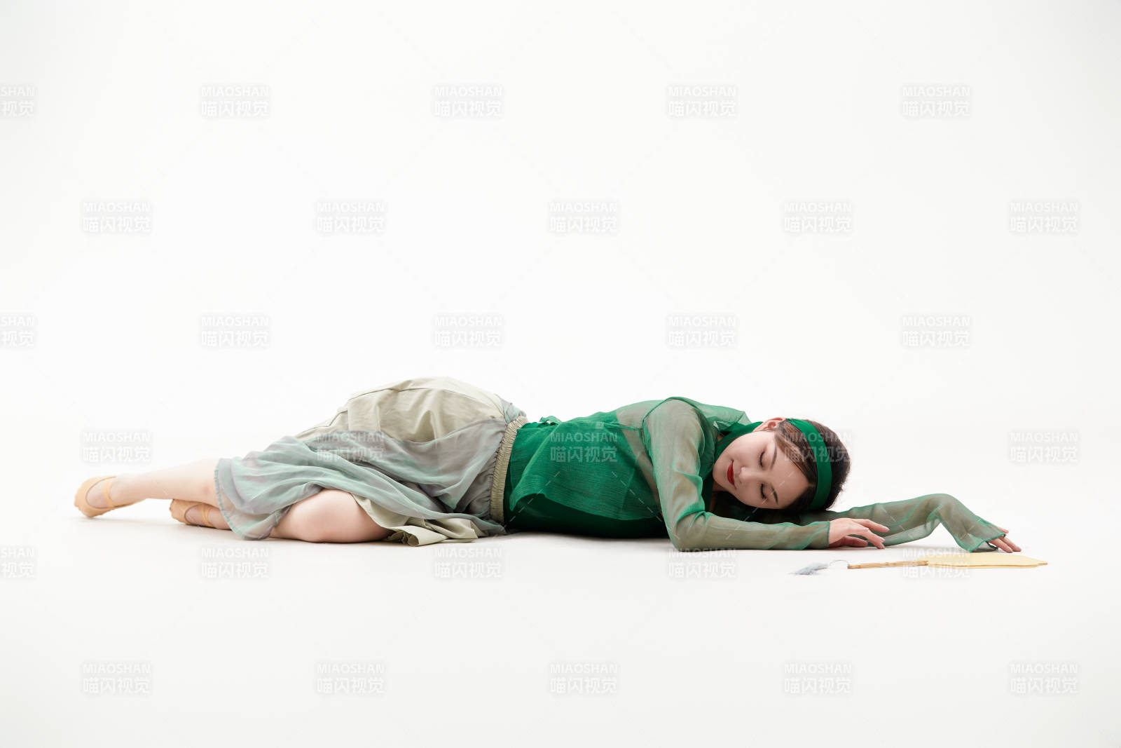 身穿青色古典舞蹈服装手拿蒲扇跳舞的少女图片