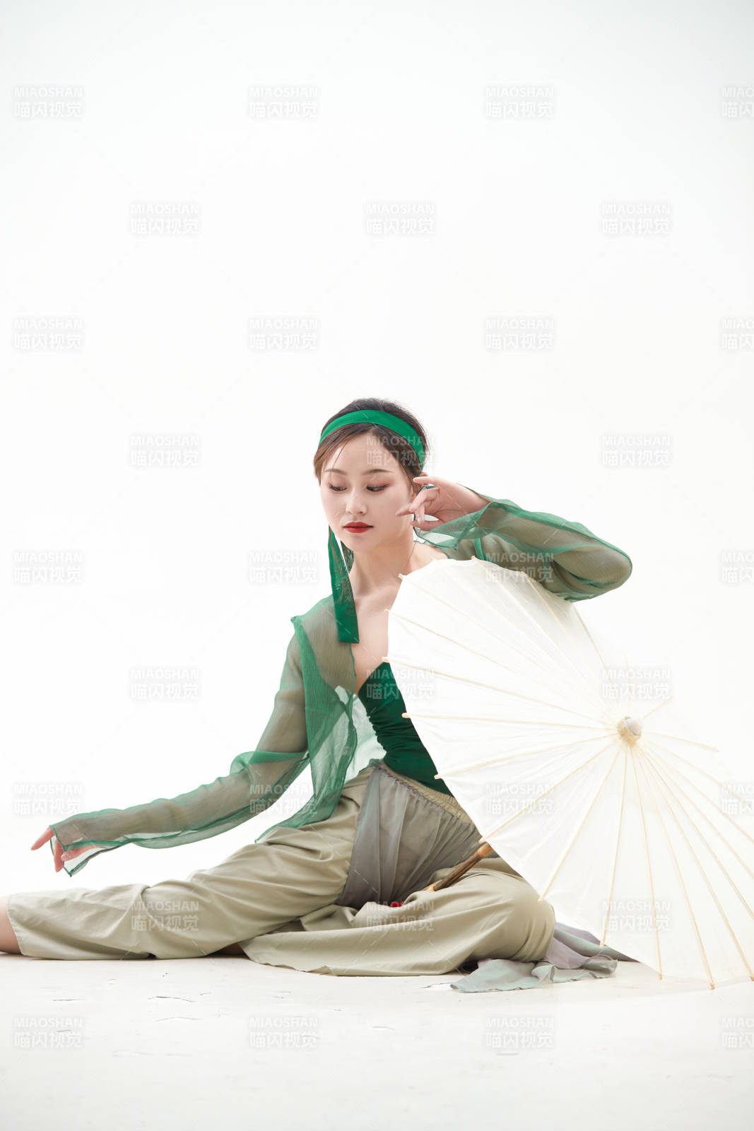 身穿青色古典舞蹈服装手拿蒲扇跳舞的少女图片