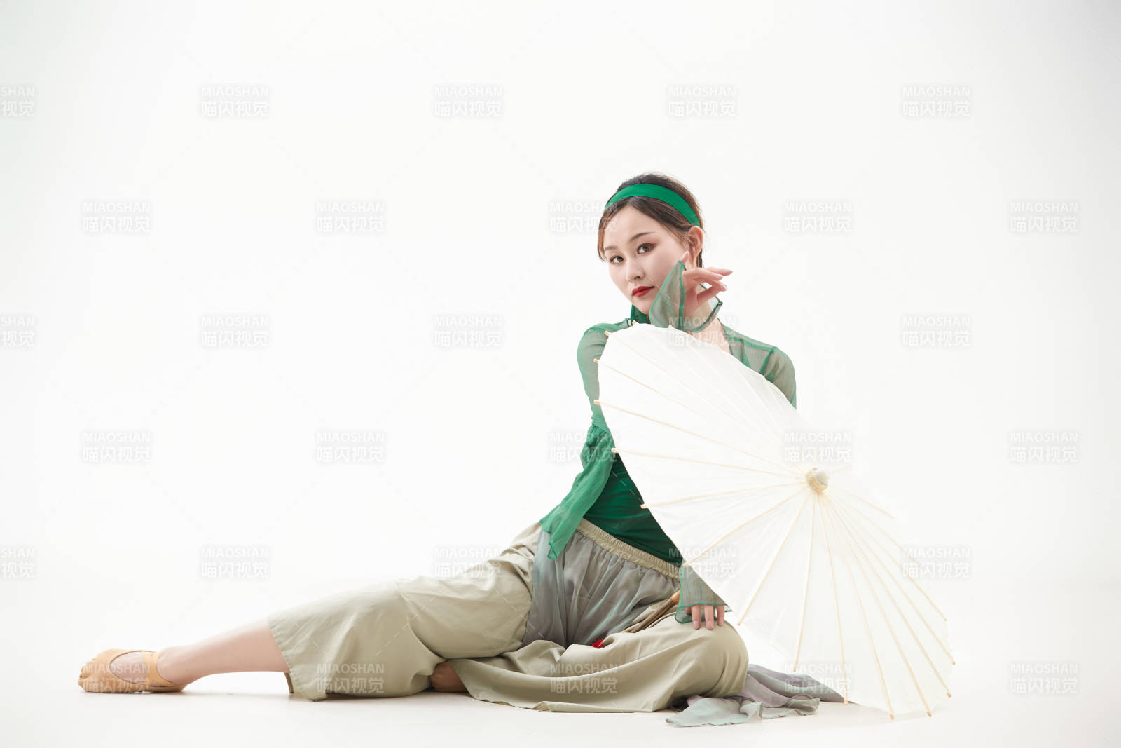 身穿青色古典舞蹈服装手拿蒲扇跳舞的少女图片