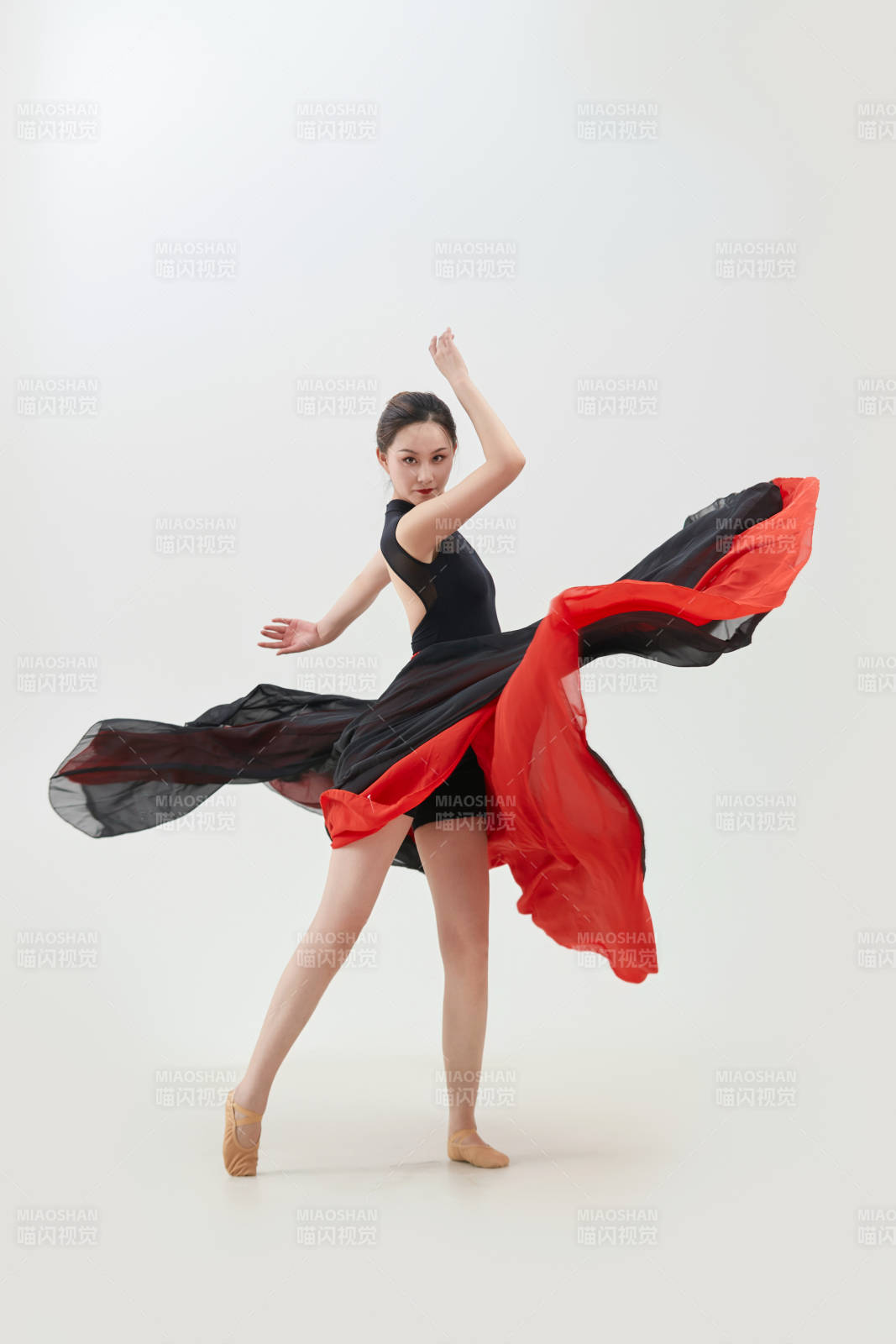 身穿红黑相间的舞蹈长裙翩翩起舞的少女图片