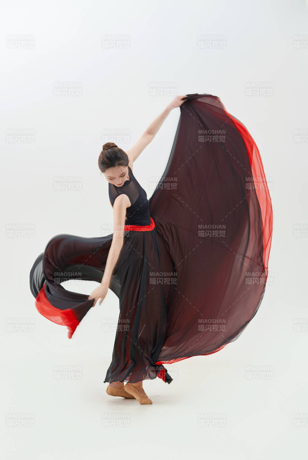 身穿红黑相间的舞蹈长裙翩翩起舞的少女图片