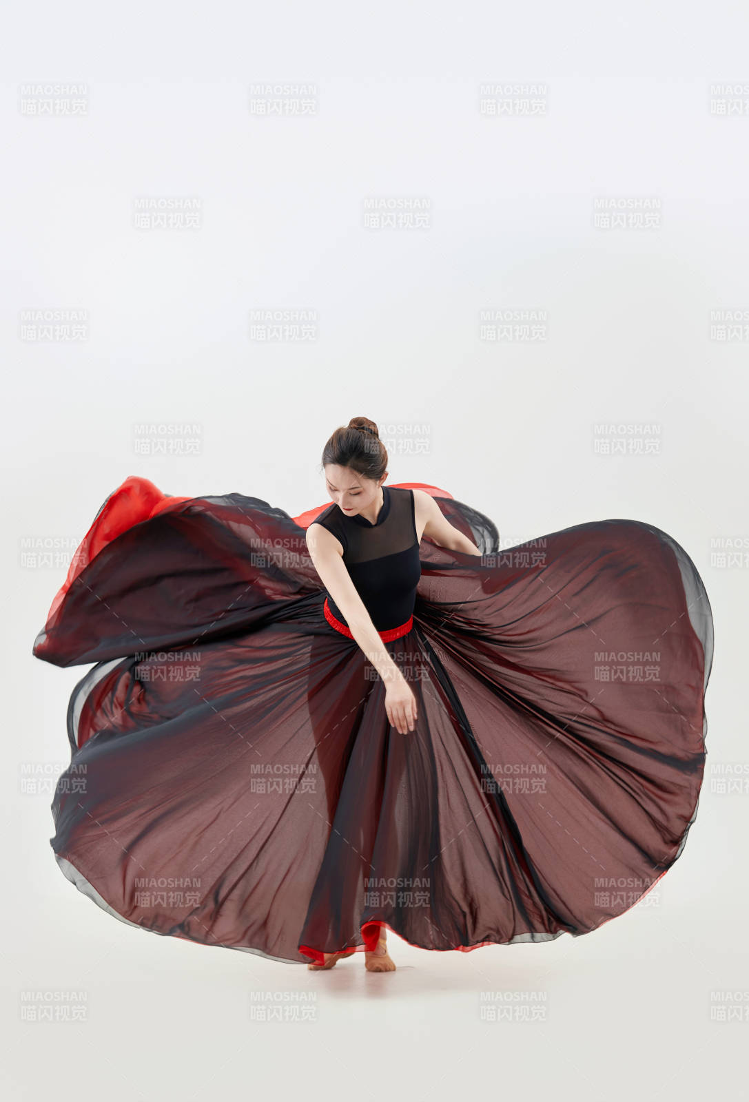 身穿红黑相间的舞蹈长裙翩翩起舞的少女图片