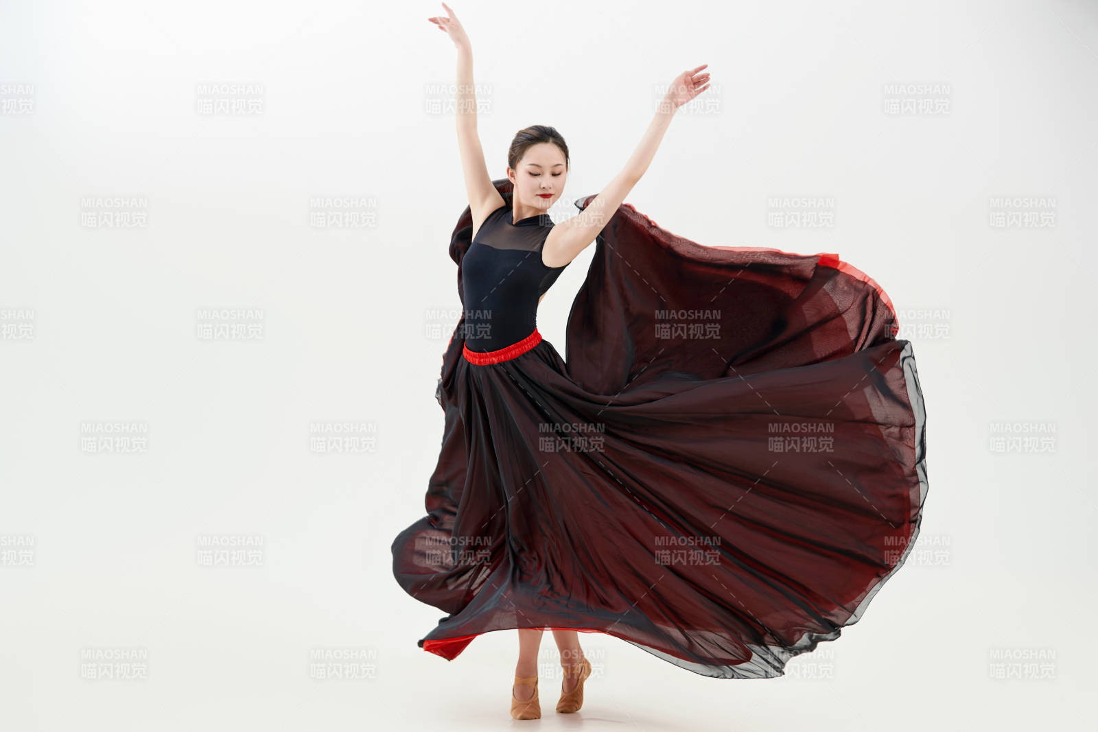 身穿红黑相间的舞蹈长裙翩翩起舞的少女图片