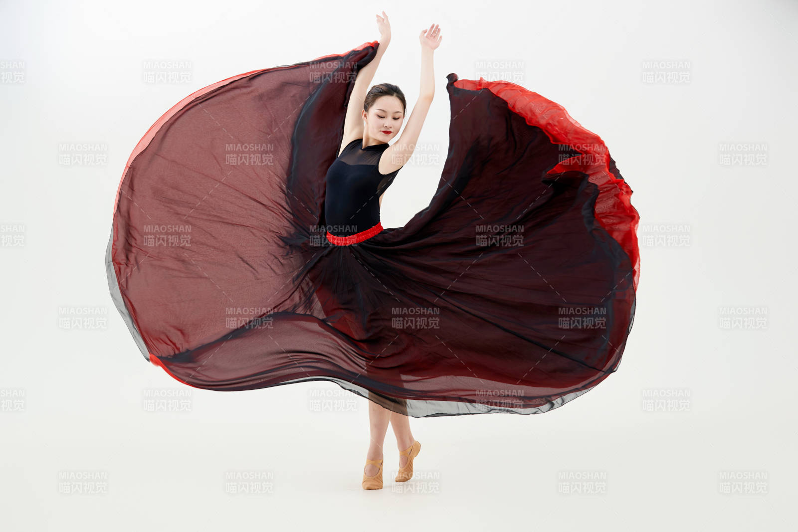 身穿红黑相间的舞蹈长裙翩翩起舞的少女图片