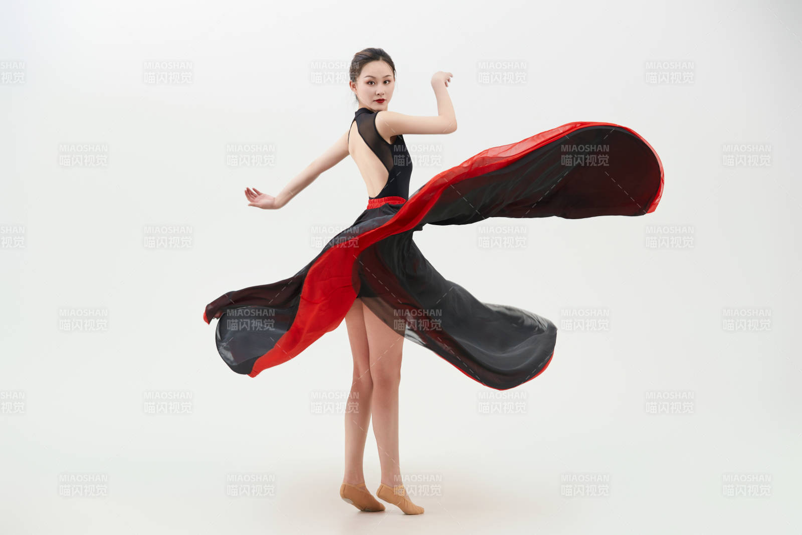 身穿红黑相间的舞蹈长裙翩翩起舞的少女图片