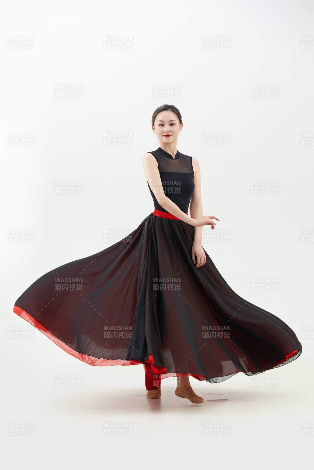身穿红黑相间的舞蹈长裙翩翩起舞的少女图片