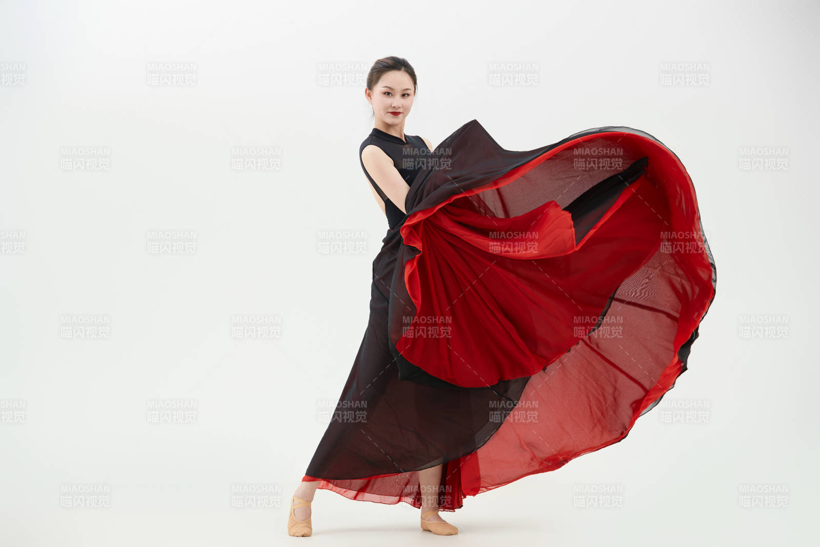 身穿红黑相间的舞蹈长裙翩翩起舞的少女图片