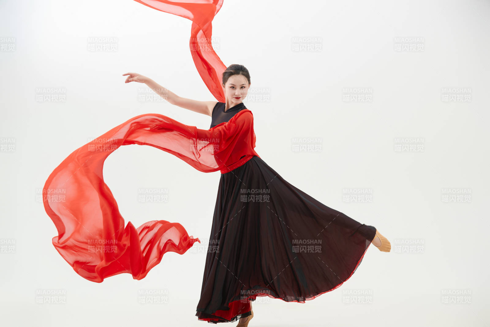 身穿红黑相间的舞蹈长裙翩翩起舞的少女图片
