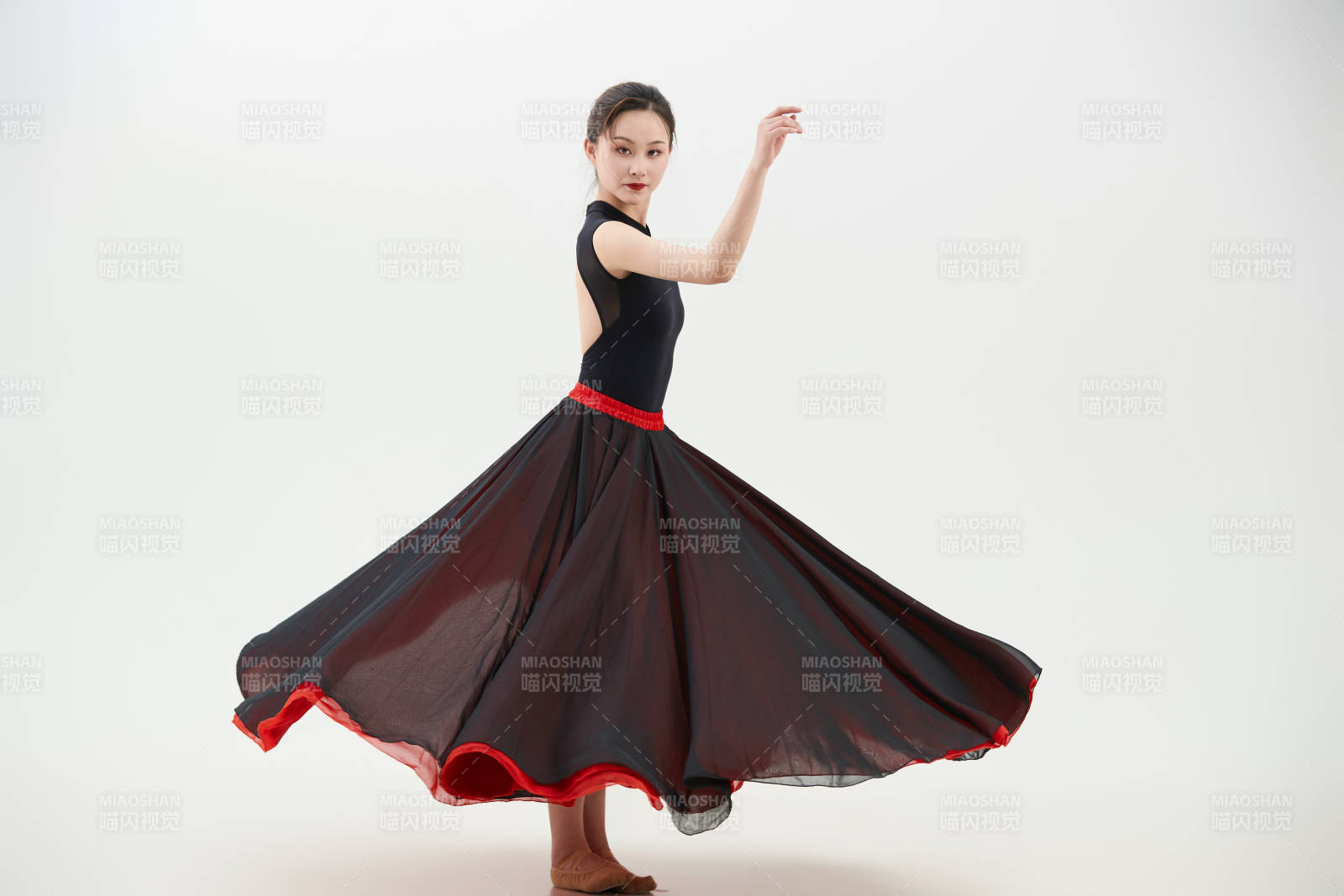 身穿红黑相间的舞蹈长裙翩翩起舞的少女图片