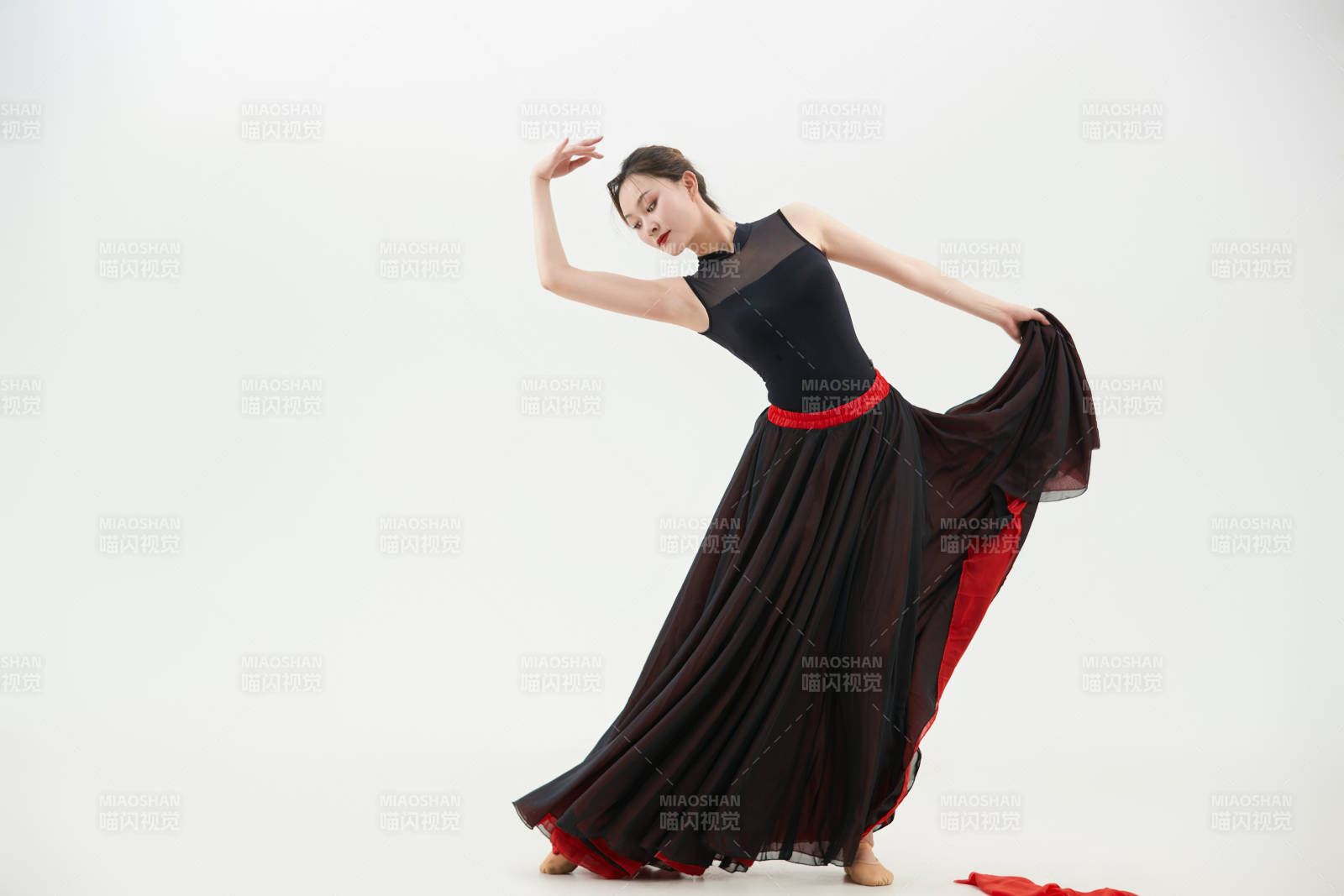 身穿红黑相间的舞蹈长裙翩翩起舞的少女图片