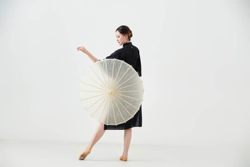 穿中式旗袍手拿油纸伞翩翩舞蹈的亚洲少女舞者图片