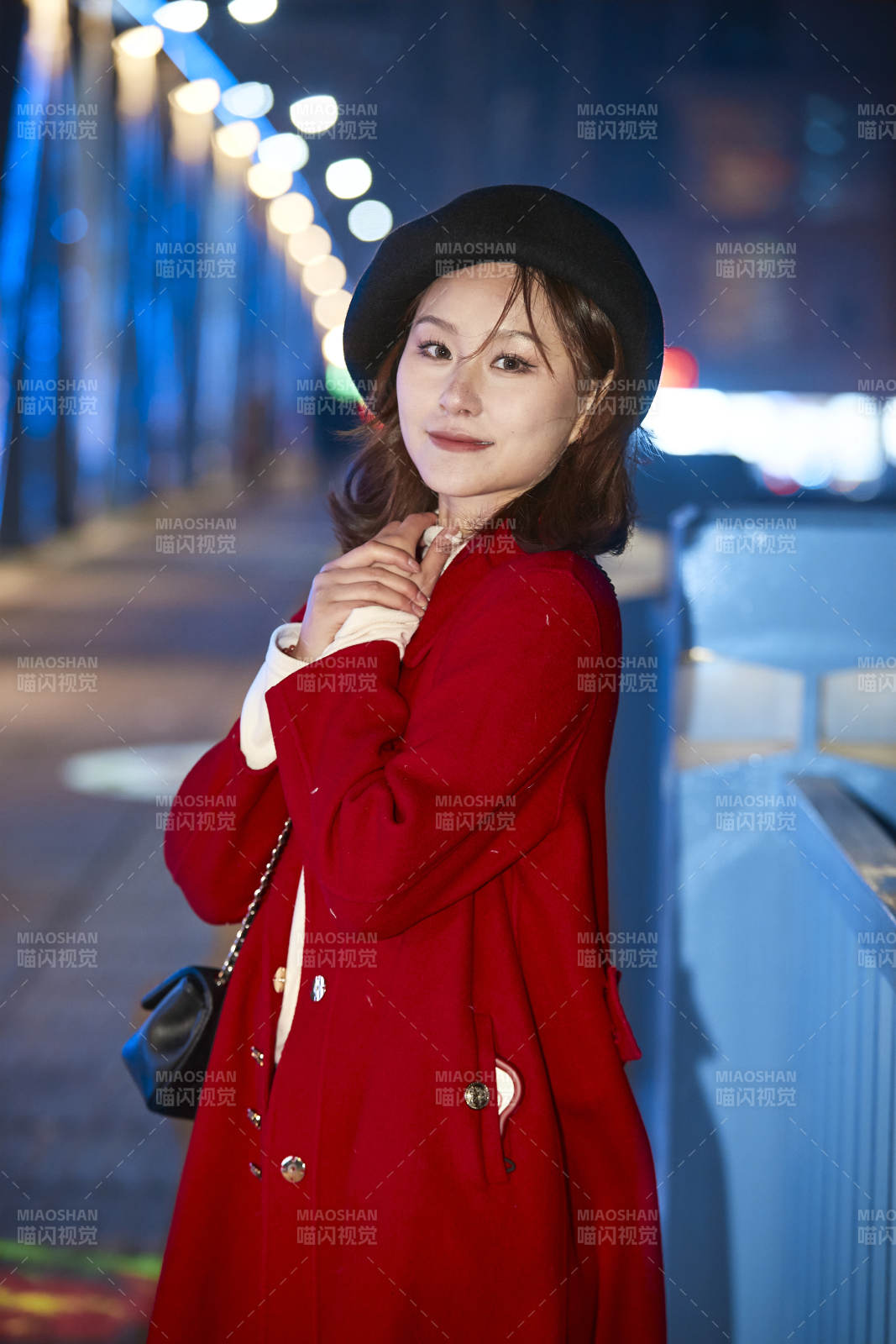 夜晚在繁华灯火的街头拍照的亚洲少女图片