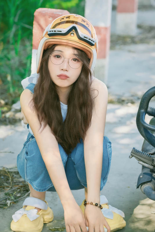 穿着骑行服饰佩戴头盔游玩的东方美女图片