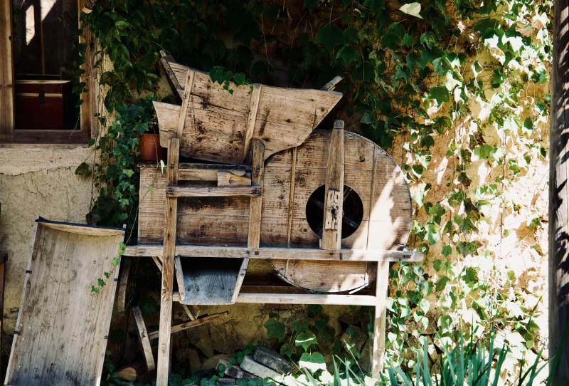 旧木制谷风车静立庭院图片