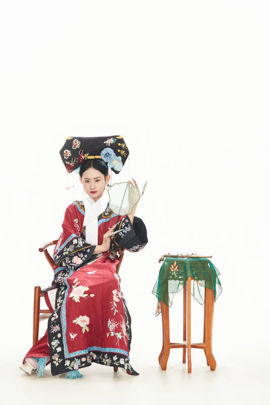 白色背景下穿着中国清朝宫廷服饰的少女图片