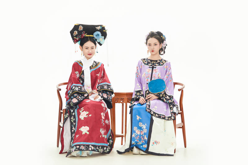 白色背景下穿着中国清朝服饰的两名少女图片