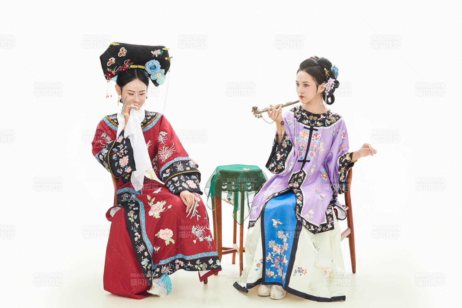 白色背景下穿着中国清朝服饰的两名少女图片