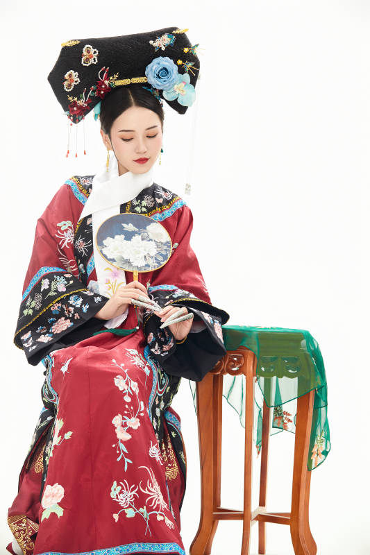 白色背景下穿着中国清朝宫廷服饰的少女图片