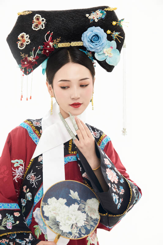 白色背景下穿着中国清朝宫廷服饰的少女图片