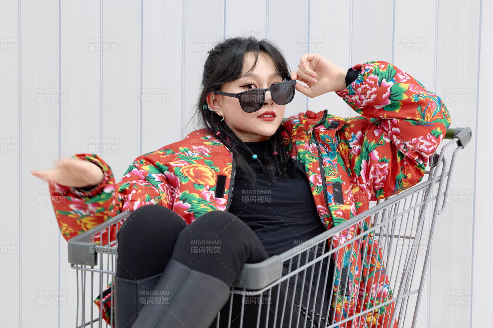 坐在商场超市购物车拍照玩乐的亚洲美女图片