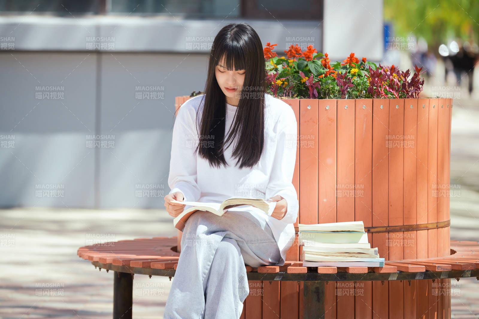 户外校园里读书学习的女大学生图片