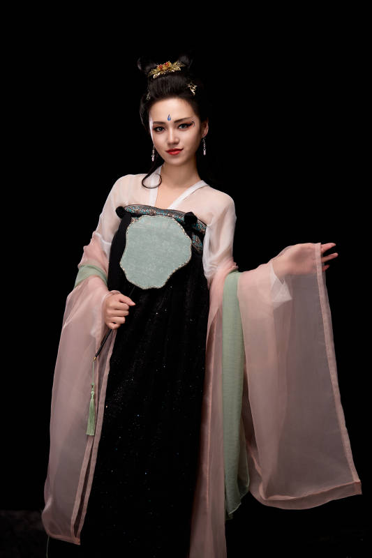 手持轻扇展示唐代服饰妆容造型的东方女性图片